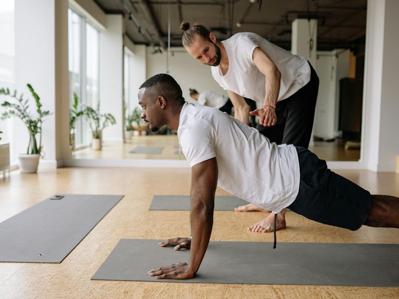 Man focused on correct form during a plank exercise.